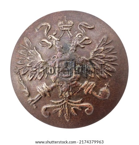 Copper button tsarist Russia factory brothers Bukh St. Petersburg with the emblem of Br.Bukh and the emblem of a double-headed eagle with a scepter and a crown Royalty-Free Stock Photo #2174379963
