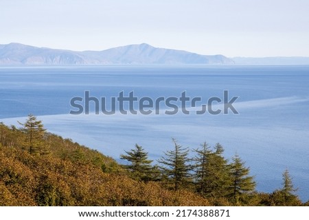 Beautiful seascape. Sea view from the coast. Mountains in the distance. Blue water. Nature of Siberia and the Russian Far East. Sea of Okhotsk, Magadan region, Russia. Great for background. Royalty-Free Stock Photo #2174388871