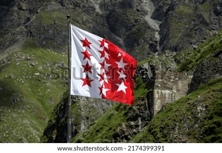 Valais Flags, sight from mountain lake Dix, Valais, Switzerland, swiss alps the biggest dam in Europe. Royalty-Free Stock Photo #2174399391