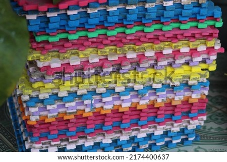 pile of colorful square rugs