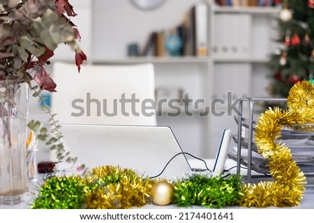 Workplace desk with laptop in white modern office at New Year