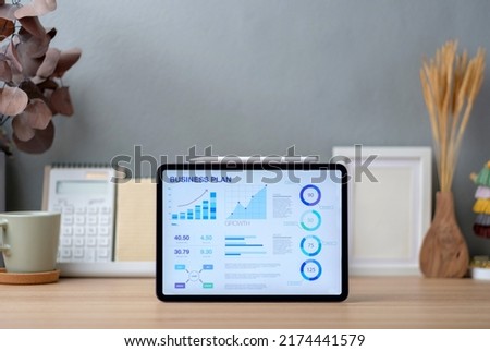 business plan on tablet on working desk decor with stationery at home