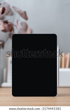 Blank screen tablet on working desk decor with stationery at home