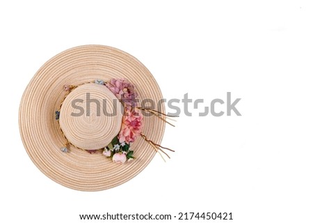 Closeup studio top view isolated shot of beautiful fashionable Asian modern classic style lady woman wicker woven weaving rattan handmade handicraft hat with dry flowers hatband on white background. Royalty-Free Stock Photo #2174450421