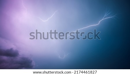 A strong storm with bright lightning illuminating ominous clouds. Exotic image of the texture of storm clouds. Adverse weather conditions. Picturesque photo wallpaper. Climate change. Force of nature. Royalty-Free Stock Photo #2174461827