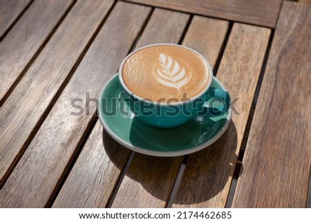 Cup of aromatic hot coffee on wooden table
