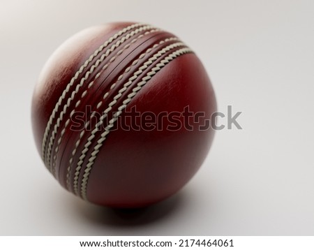 A regular red cricket ball with white stitching on an isolated background - 3D render
