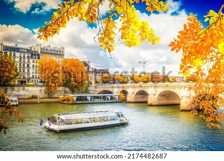 Pont Neuf and river Seine waters with cruise ship, blue sky with clouds, Paris at autumn, France with sunshine Royalty-Free Stock Photo #2174482687
