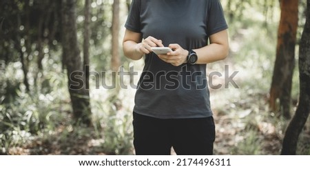 People using mobile phone  in summer forest