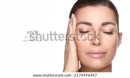 Anti aging treatment and plastic surgery concept. Beautiful young woman with hand on cheek and eyes closed with a serene expression and white arrows over face. Isolated on white with copy space Royalty-Free Stock Photo #2174496447