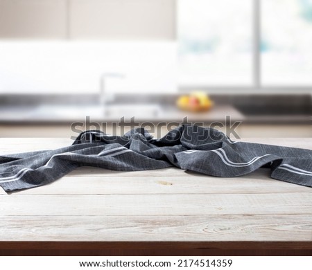 Crumpled linen tablecloth on wooden desk perspective. Mock up. Selective focus.