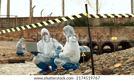 Ecologists sample water contaminated with dangerous, waterhazard toxins into tubes, Scientist or Biologist in protective waste water from industrial for analyze, problem environment, Testing toxic. Royalty-Free Stock Photo #2174519767