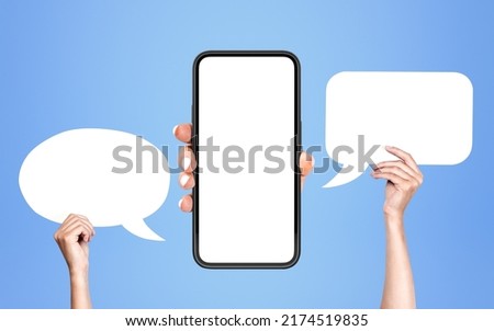 Woman hand show smartphone mock up copy space screen, hands holding blank speech bubble on blue background. Concept of social media and ad Royalty-Free Stock Photo #2174519835