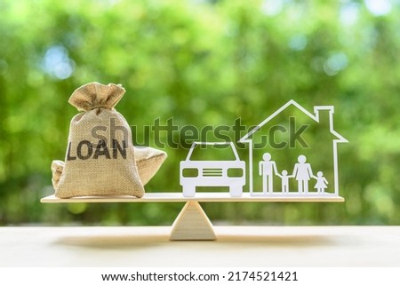 Family financial management, mortgage and payday loan or cash advance concept : Loan bags, family in a house on balance scale, depicts short term borrowing, high interest rate based on credit profile Royalty-Free Stock Photo #2174521421