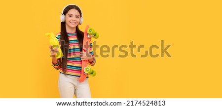 skateboarding. happy child in headphones with penny board. teen girl listen music. Casual teen child horizontal poster. Banner header, copy space.