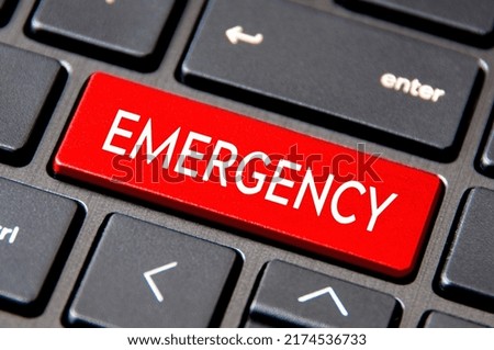Emergency text on Laptop Keyboard Key. Urgency concept