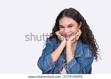 A cute asian woman with a beaming smile with braces. Isolated on a white backdrop.