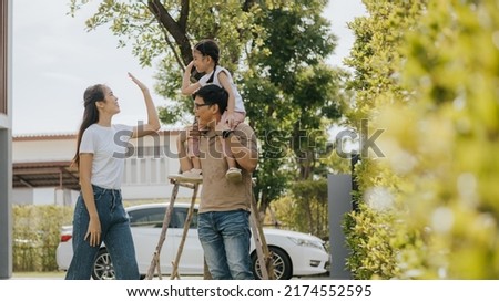 Family having fun time at home. Asian family with little kids daughter playing together in house backyard outside. Happy family time. Royalty-Free Stock Photo #2174552595