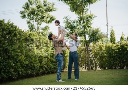 Family having fun time at home. Asian family with little kids daughter playing together in house backyard outside. Happy family time. Royalty-Free Stock Photo #2174552663