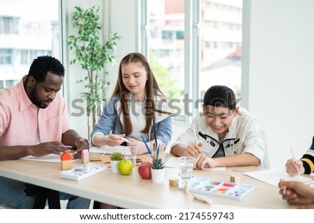 Part-time art teacher with children drawing, practicing drawing and painting. Special classroom. Concept Home school, teaching modifications for children.