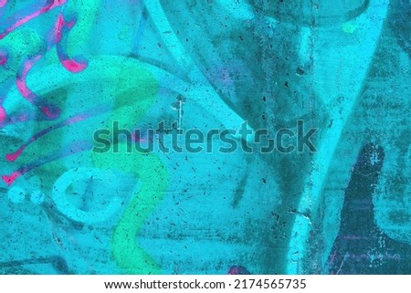 Closeup of colorful teal, pink and blue urban wall texture. Modern pattern for wallpaper design. Creative modern urban city background for advertising mockups. Grunge messy street style background Royalty-Free Stock Photo #2174565735