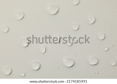 Abstract water drops on grey background, macro, Bubbles close up, Cosmetic liquid drops, Flat lay pattern.