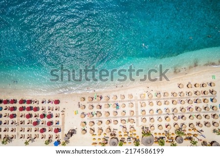 Aerial top down view to the emerald sea of the popular beach Akti Iliou, Alimos, Athens, Greece, during summer time Royalty-Free Stock Photo #2174586199