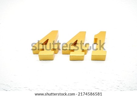    Number 441 is made of gold-plated teak, 1 cm thick, laid on a white painted aerated brick floor, giving good 3D visibility.                                Royalty-Free Stock Photo #2174586581