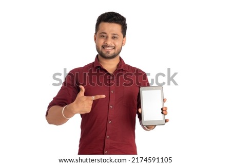 Young handsome man, businessman showing a blank screen of a smartphone or mobile or tablet phone on white background 