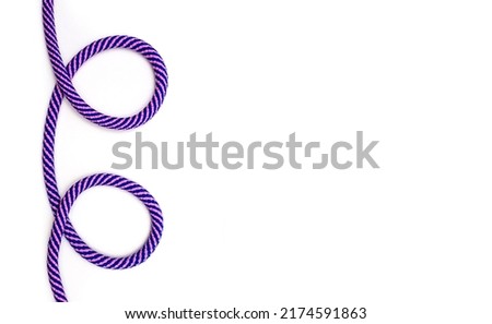 Multicolored rope with loops on a white background and free space for text. Decor in the form of a multi-colored rope. Strong rope for rock climbing and heavy loads. Reliable strong rope
