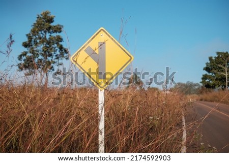 go straight or turn left traffic sign on blue sky background.