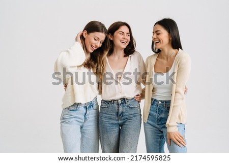 Three gorgeous brunette women posing at camera together isolated over white background Royalty-Free Stock Photo #2174595825