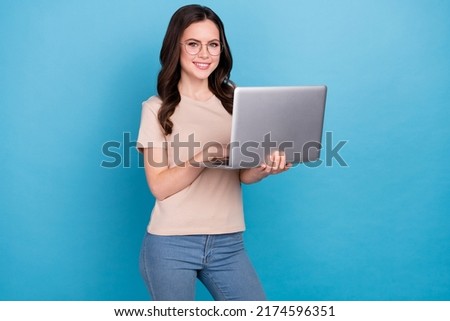 Photo of cheerful young business lady working on new start-up chatting with colleagues isolated on blue color background