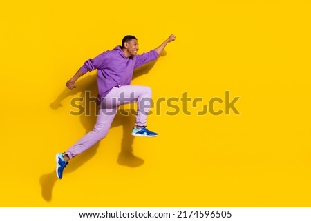 Full length body size view of handsome trendy strong cheerful guy jumping striving isolated on vivid yellow color background Royalty-Free Stock Photo #2174596505