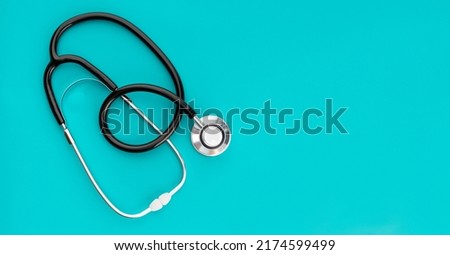 Health care medical background banner. Flat lay of stethoscope on green background. Copy space
