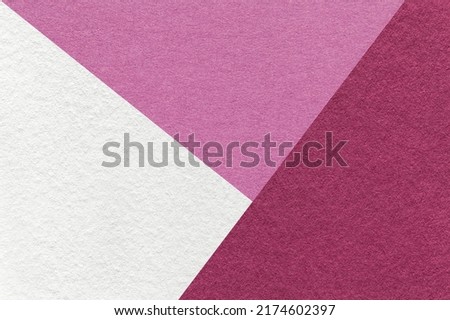 Texture of craft white, purple and wine shade color paper background, macro. Structure of vintage abstract lilac cardboard with geometric shape and gradient. Felt backdrop closeup.