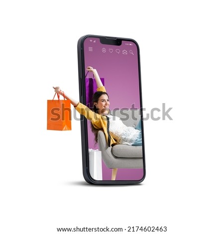 Happy fashionable young woman sitting and holding shopping bags in a smartphone, she is doing online shopping, blank copy space Royalty-Free Stock Photo #2174602463