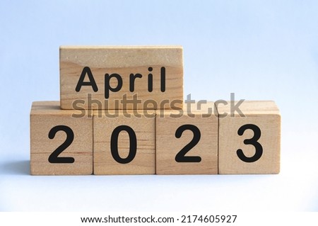 April 2023 text on wooden blocks with white color background. Copy space and month concept