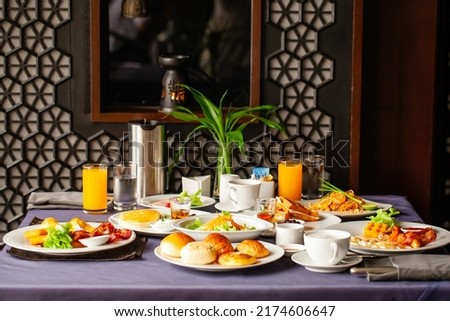 Food and drinks served on table for two persons on breakfast or brunch at morning in restaurant. Concept of weekend vacation, rest on holiday in modern city hotel. Dinner or lunch in cafe in resort. Royalty-Free Stock Photo #2174606647