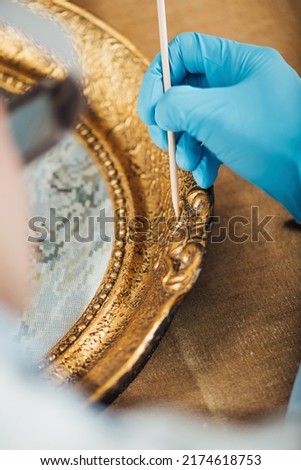 Ornate gold-plated picture frame restoration
