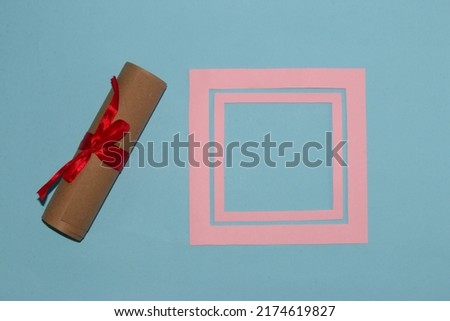 romantic retro design, rolled scroll with a message you can write and a frame next to it that serves as copy space, product space, creative modern design, pastel blue background