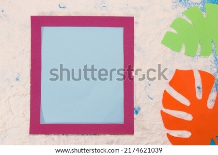 tropical design, beach with cyclamen color frame and pastel blue copy space, next to colorful monstera jungle leaves