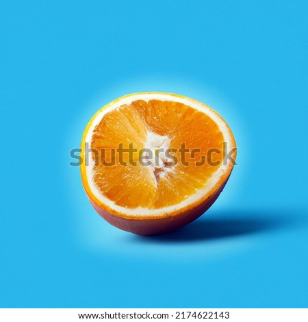 orange sliced in half laying on a blue background