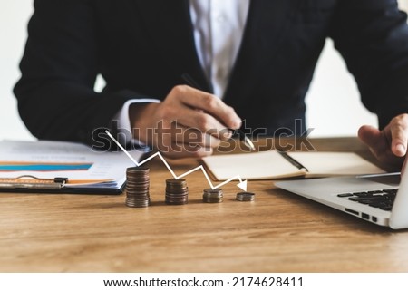 Businessmen bankrupt from recession, lose global business competitiveness, chart the global recession leading to bankruptcy and crisis. Royalty-Free Stock Photo #2174628411