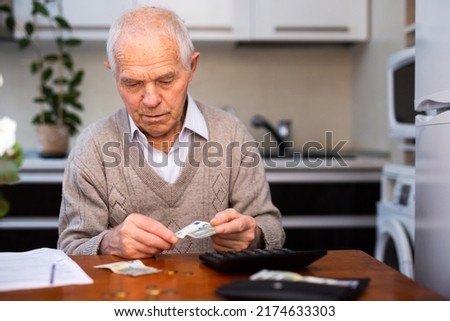 desperate old man pensioner counting his last Royalty-Free Stock Photo #2174633303