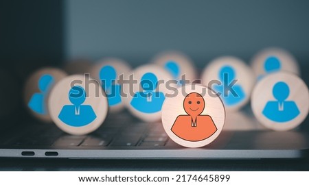 The wooden block is placed on the laptop, the concept of choosing and giving opportunities to the top performers, and promotion. Royalty-Free Stock Photo #2174645899