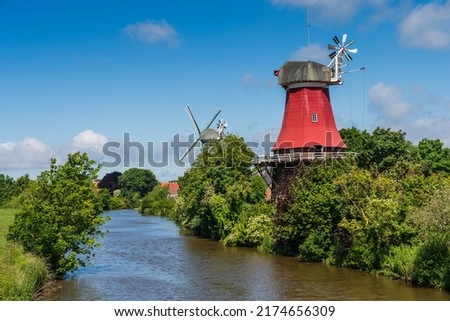 The windmills of Greetsiel at the north sea, East Frisia, Lower Saxony, Germany Royalty-Free Stock Photo #2174656309