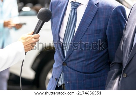Reporter making media or press interview, female hand holding microphone