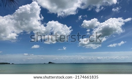 Sunny sea view in white clouds and clear blue sky