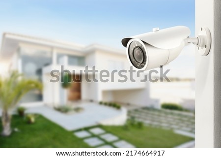 Three quarter view of varifocal surveillance camera, with a house on background Royalty-Free Stock Photo #2174664917